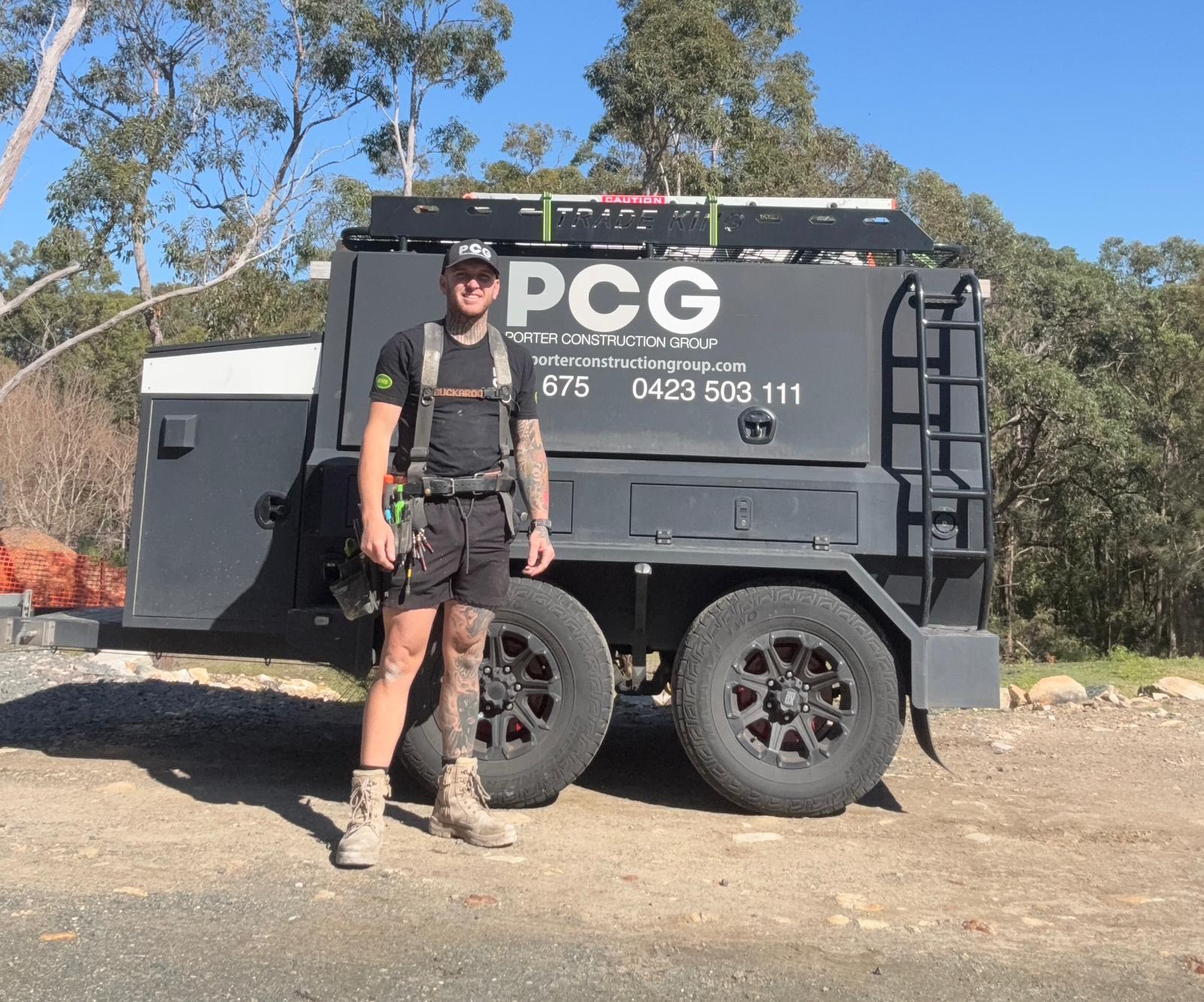 Josh Porter standing in front of the PCG work trailer